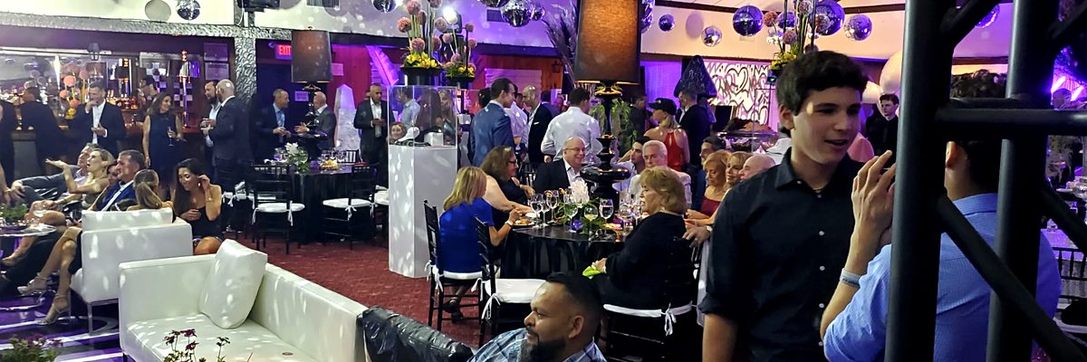 Guests enjoying cocktail hour with lounge seating and disco balls