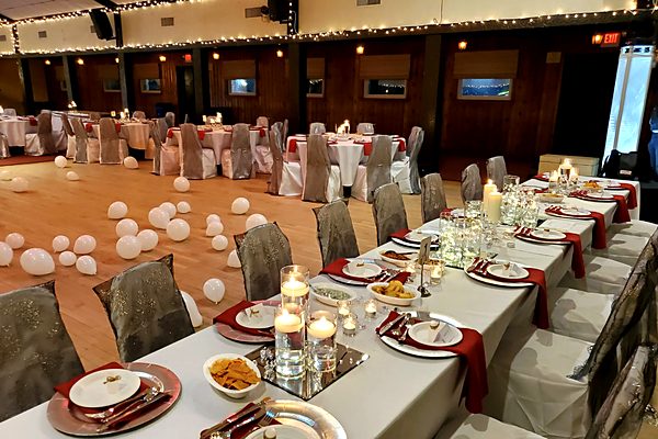 Elegant head table with floating candles and silver charger plates