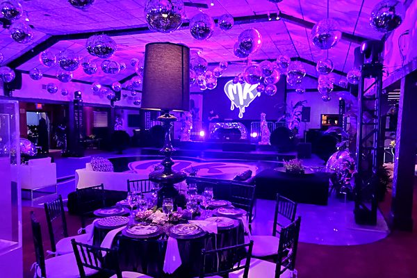 Stage area with custom monogram projection and DJ setup