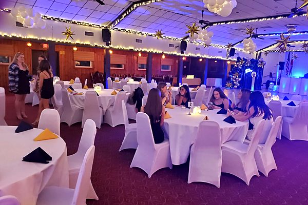 Sweet 16 party with blue uplighting and gold star decorations